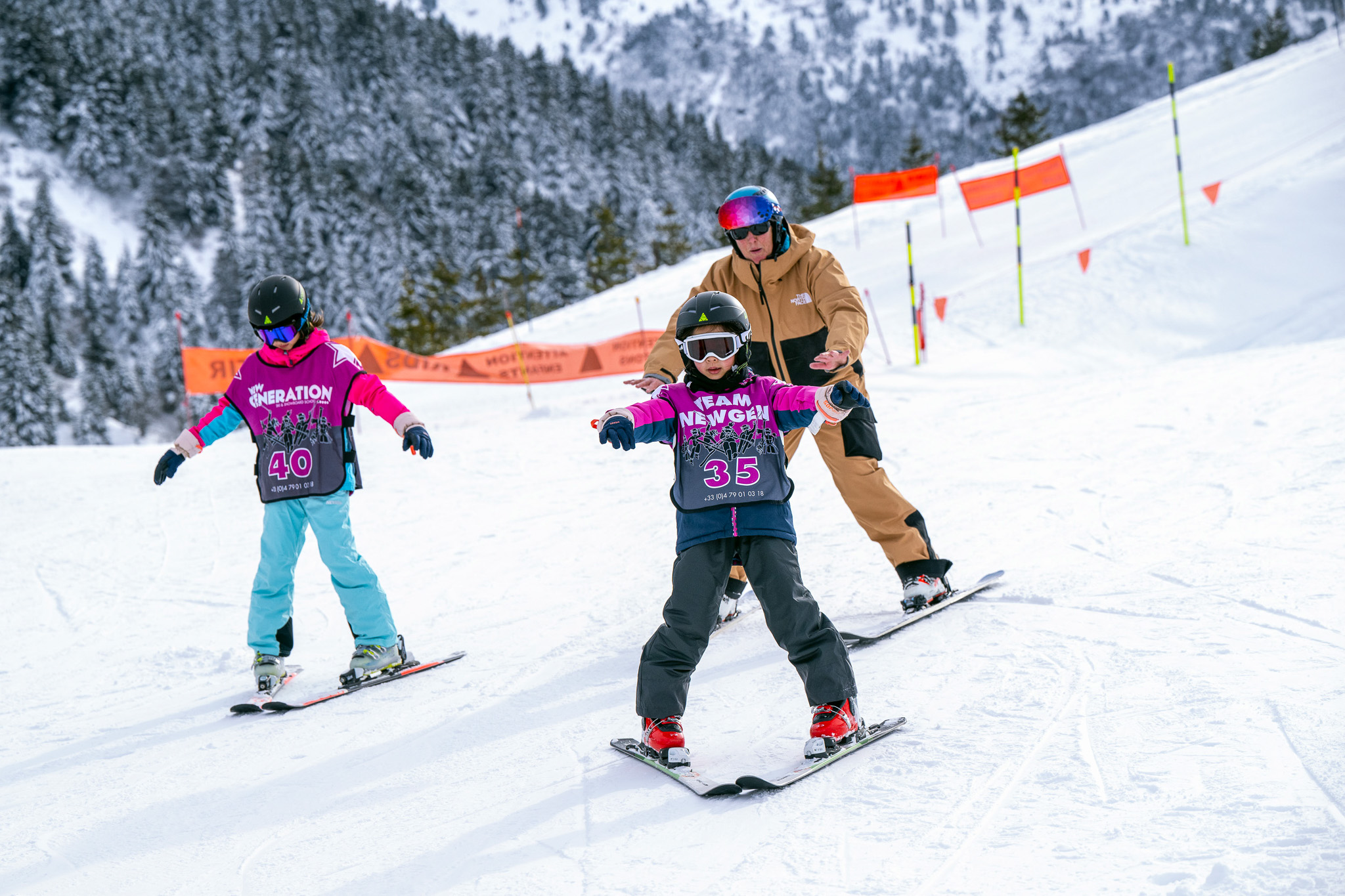 Children doing snowplough on their own