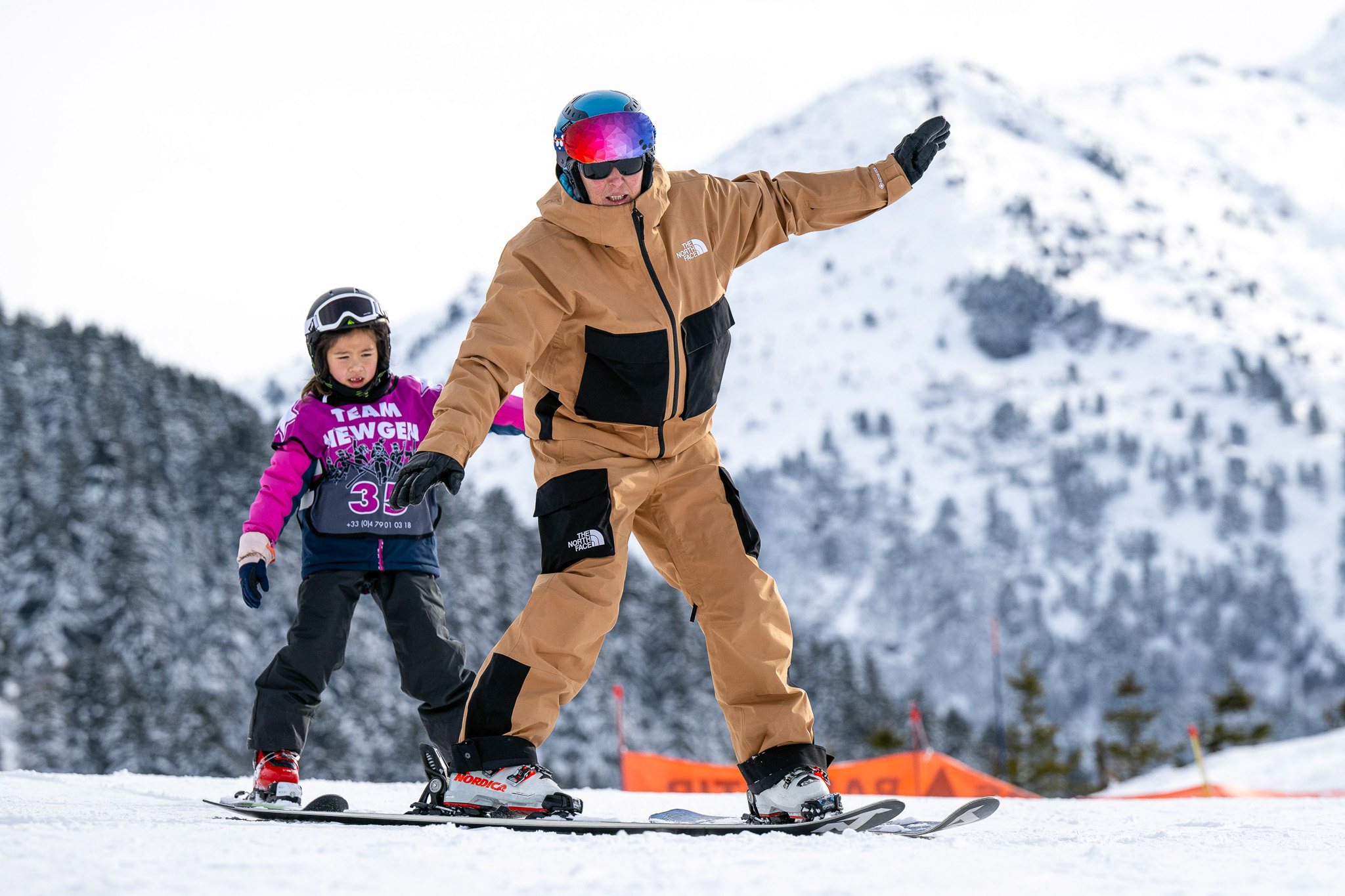 Children following insturctor in snowplough