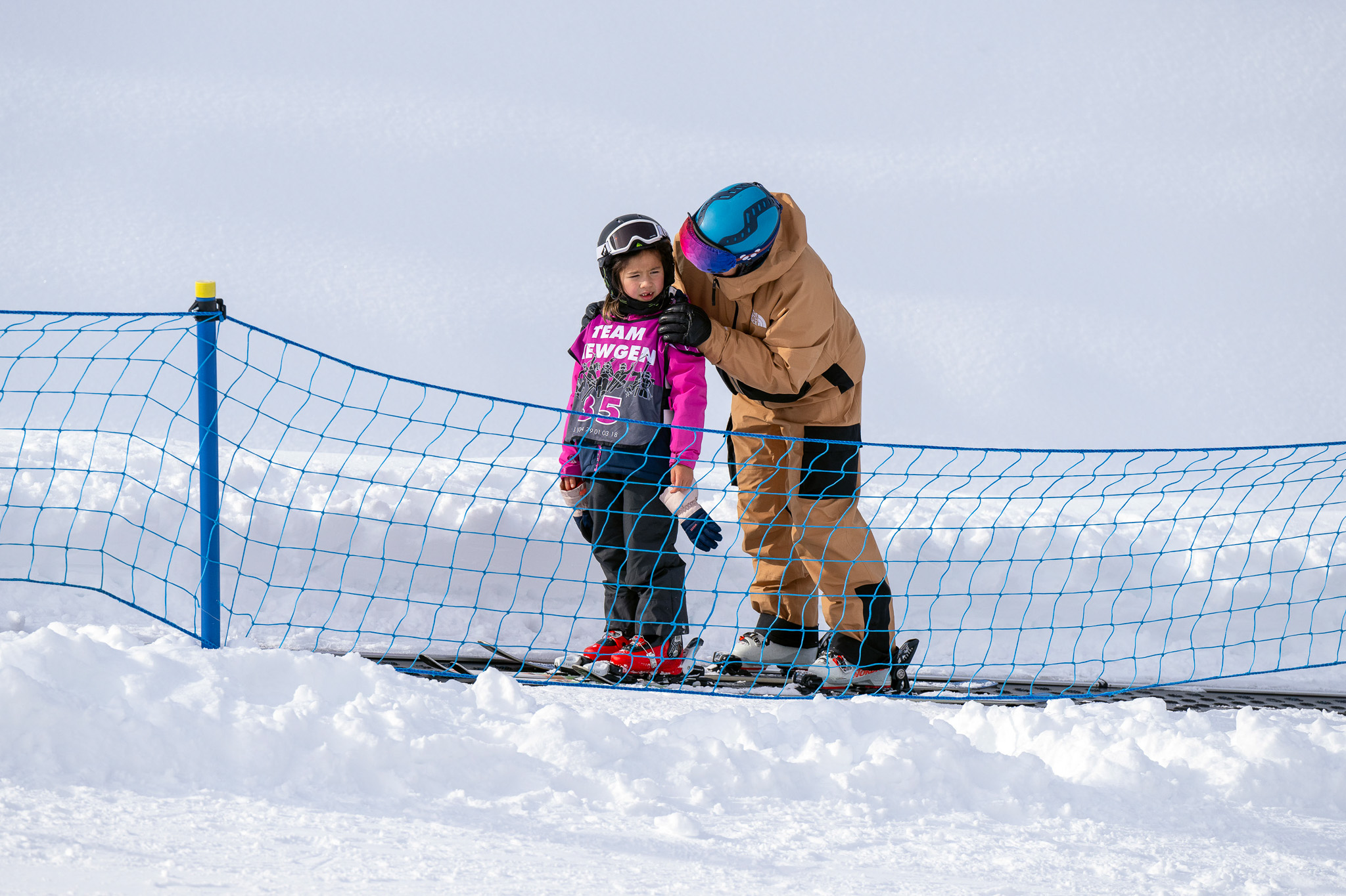 Instructor reassuring child on lesson