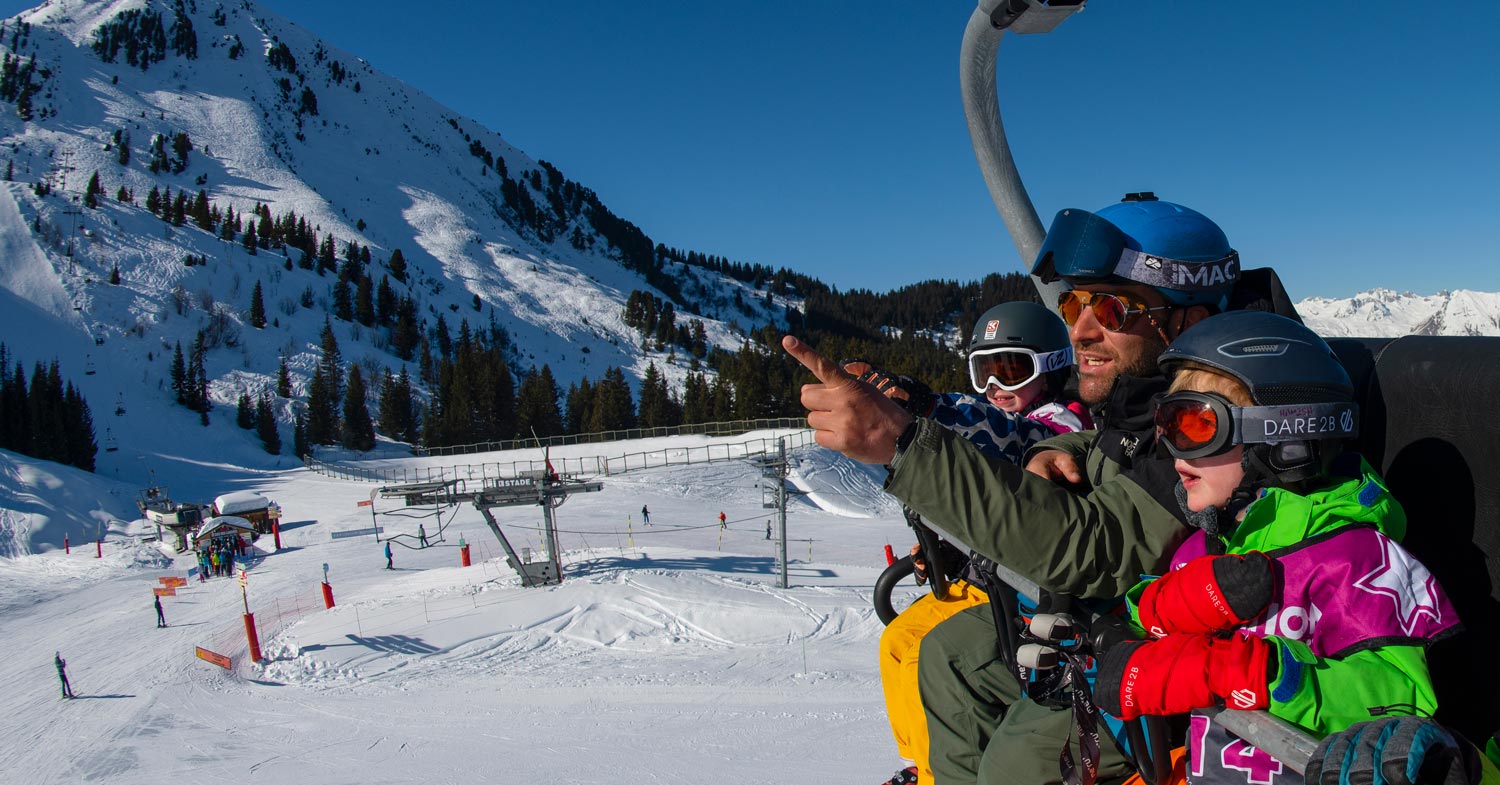 Children on a ski lift with a ski instructor