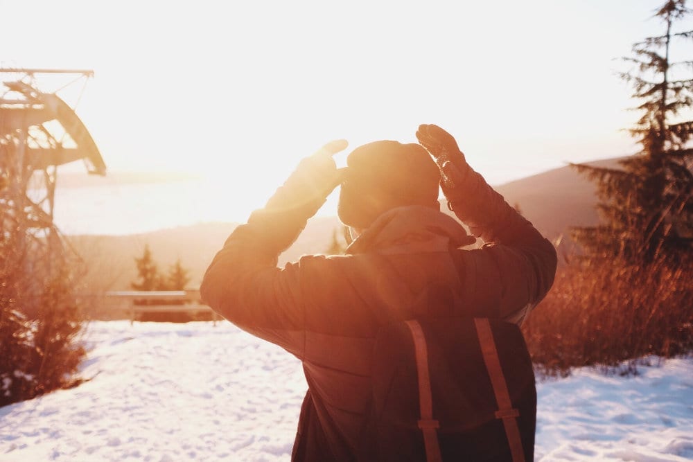 A skier watching the sunset